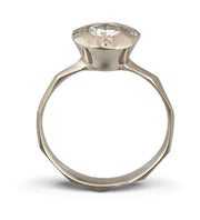 Side view of a contemporary halo style engagement ring featuring a center Moissante and 4 small stones in North, south, east west positions