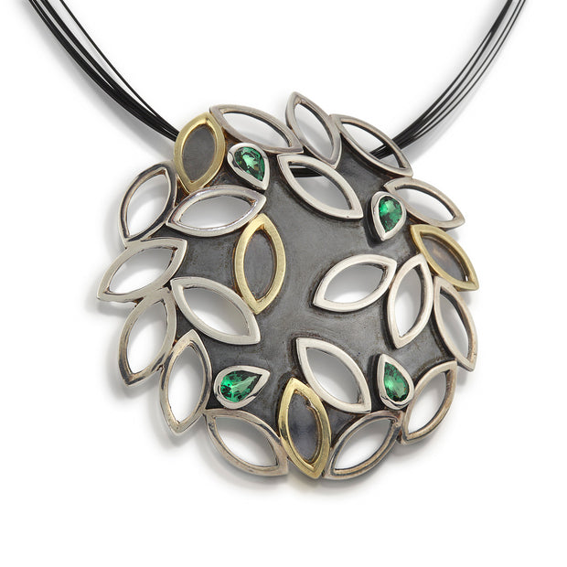Full view of Large Leaf Cluster Pendant. This medallion-type necklace can also be worn as a brooch and is reminiscent of scattered autumn leaves. Handmade in sterling silver (blackened and shiny), 18k gold, tsavorite garnets