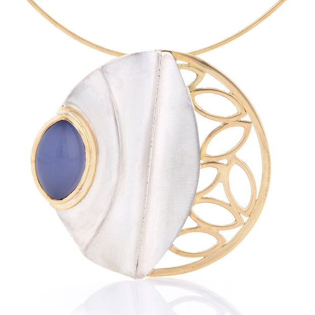 Full view of pendant on Waning Chalcedony Necklace. Large fold-formed sterling silver medallion-type pendant with 18k gold leaf-like forms and a gorgeous 9.2ct blue chalcedony.